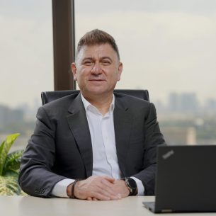 Confident middle-aged businessman in an elegant office with city view.